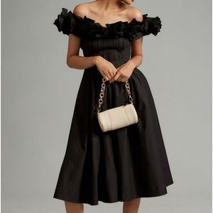 Black cotton classic. Ruffled off the shoulder neckline is stunning!